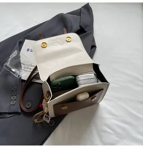 Detail view of the open two-tone shoulder bag showing interior capacity and magnetic closure
