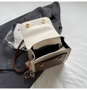 Interior view of the cream and brown contrast backpack with main compartment and bear charm