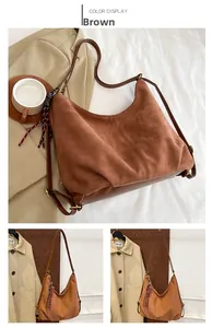 Detail of a brown matte suede tote bag with a decorative silk scarf on the side