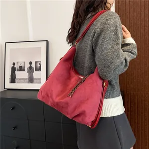 Retro red faux suede hobo bag with zipper closure and woven decorative puller