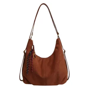 Vintage brown suede hobo bag with braided tassel and vertical stitching details