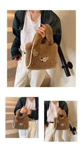 Detail der braunen Plüschtasche mit Bärenbestickung und einem Tragegriff aus Perlenkette