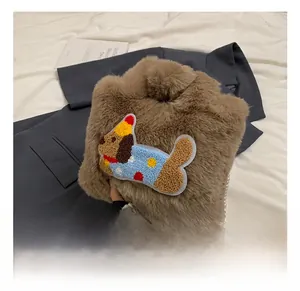 Details der braunen Plüschtasche mit Cartoon-Hundestickerei und elegantem Perlenhenkel