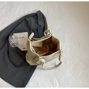 Macro shot of cream PU leather tote bag interior with woven handle and brown lining