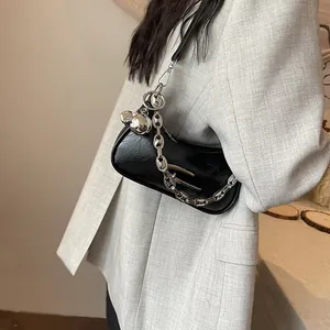 Chic black pleated leather underarm bag with bold silver chain and metallic charms