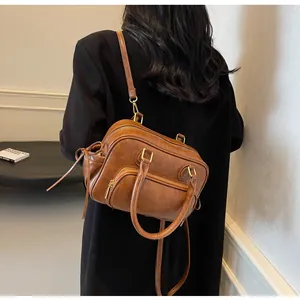 Brown retro PU leather Boston bag shown on shoulder in minimalist interior scene