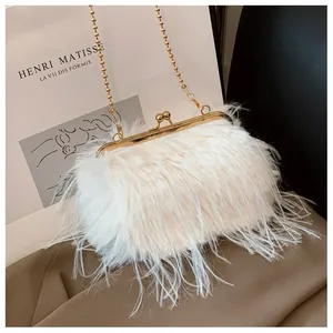Detail of white feather chain bag with golden metal frame and plush ostrich-style texture