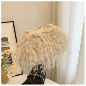 Detail of a beige faux fur clutch bag with elegant gold metal clasp and soft texture