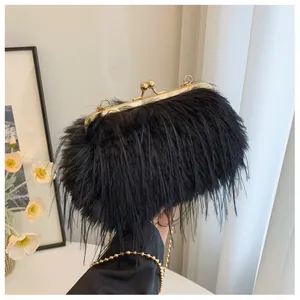 Detail of black faux fur clutch bag with gold metallic frame and vintage ball clasp