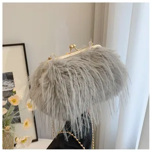 Detailed close-up of light gray faux fur handbag with golden vintage clasp and chain strap