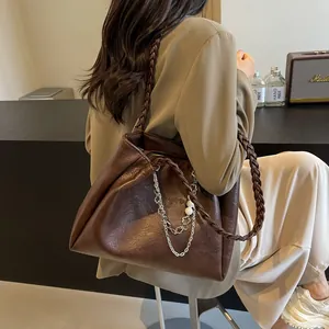 Deep brown oversized tote bag with braided handle and pearl chain decoration for women