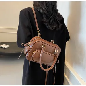 Brown vintage leather handbag shown on model for size reference and commuting style