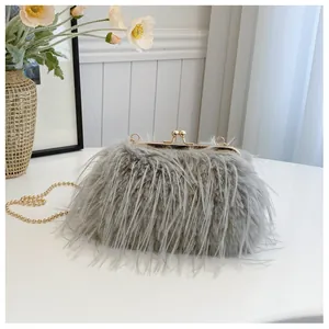 Detail of grey faux fur handbag featuring a golden clasp and elegant metal ball chain