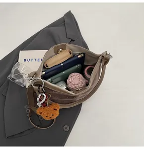Top view of brown suede bucket bag interior showing large capacity for tablet and umbrella