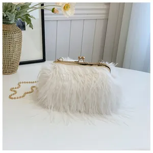 Close-up of white feather clutch with gold hardware and beaded chain strap