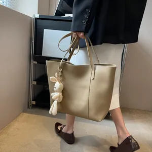 Chic khaki large tote bag in PU leather with a cute white rabbit pendant and twin handles