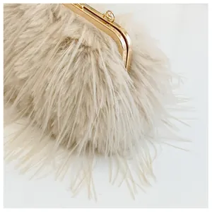 Detail of plush faux fur texture on a beige evening clutch with gold metal frame
