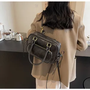 Model view showing the large capacity and retro style of the black faux leather backpack