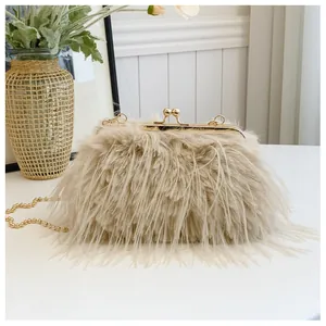Detail of cream ostrich feather evening clutch with gold bead chain and metallic clasp