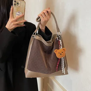 Brown suede hobo bag with white polka dots, PU leather trim and a plush bear charm