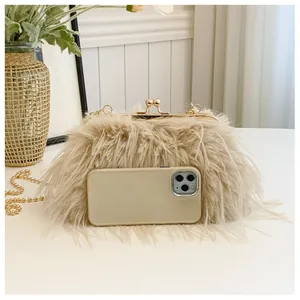 Close-up of beige faux ostrich fur handbag with gold chain strap and metal clasp detail