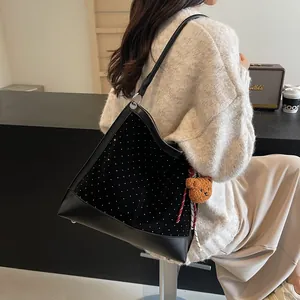 Chic black suede shoulder bucket bag with shimmering rhinestones and a cute bear charm