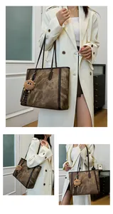 Detail of vintage brown tote bag with marble texture and plush lion charm on model