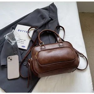 Detailed top view of dark brown PU leather backpack with vintage handles and gold zippers