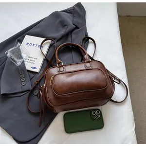 Flat lay of vintage brown leather backpack and handbag on white sheets with suit blazer