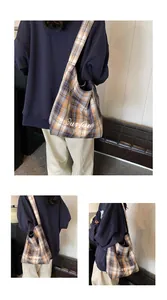 Detail of yellow checkered wool tote bag with white Ourfav Party embroidery and wide strap