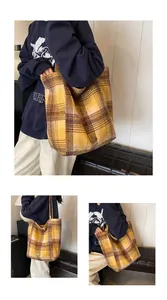 Macro shot of yellow plaid wool tote bag showing thick texture and leather brand patch