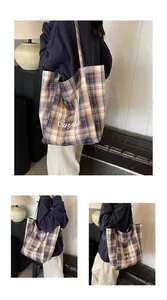 Detail of large reversible yellow plaid tote bag with Ourfave Party script print