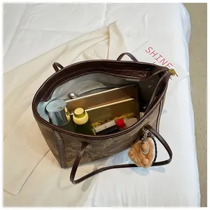 Spacious dark brown tote bag interior showing storage for tablet and essentials