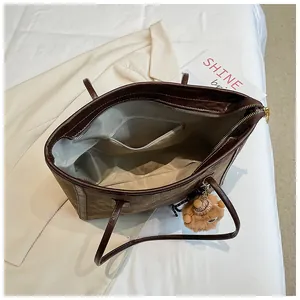 Macro detail of the interior compartment and lining of this large brown tote bag