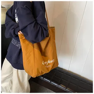 Detailed view of yellow plaid wool tote bag showing large capacity and Curfave Party print