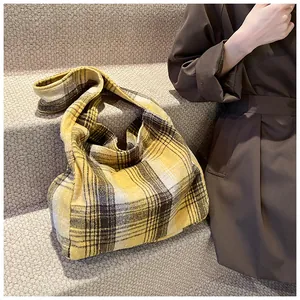 Detail of yellow wool plaid tote bag showing textured weave and spacious interior
