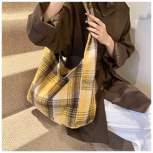 Close-up of yellow plaid hobo bag featuring thick canvas fabric and a spacious design