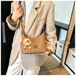 Detail of leopard print hobo bag with MAOJ leather patch and plush lamb charm