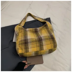 Detail of yellow plaid tote bag on white fabric background with size reference
