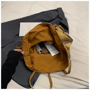 Top view of large plaid tote bag interior showing spacious storage for daily essentials