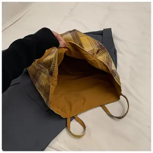 Top-down view of large yellow plaid tote bag showing spacious interior and fabric texture
