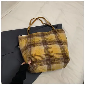Detailed shot of yellow plaid wool tote bag showing texture and soft fabric material