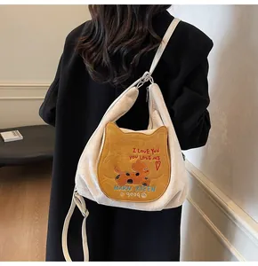Détail de la poche chat mignonne avec illustration de dessin animé et broderie sur sac crème