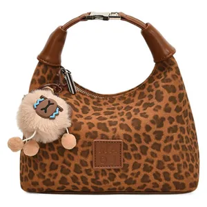 Retro leopard print faux suede handbag with leather handles and plush charm detail