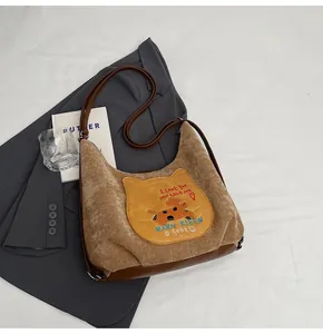 Détail du sac cabas en velours côtelé avec broderie chat et base en cuir brun