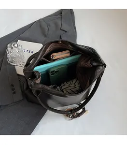 Interior view showing the large capacity and striped lining of the mocha tote bag