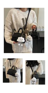 Detail of black leather mini crossbody bags with cute cloud charms and handle straps