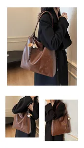 Detail of mocha brown tote bag featuring embossed logo and creative baseball keychain charm