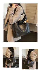 Macro detail of black leather tote bag featuring H.SHAN logo and sporty charm accessory