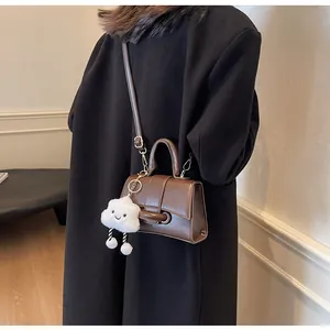 Brown vintage faux leather shoulder bag with a cute white plush cloud charm accessory